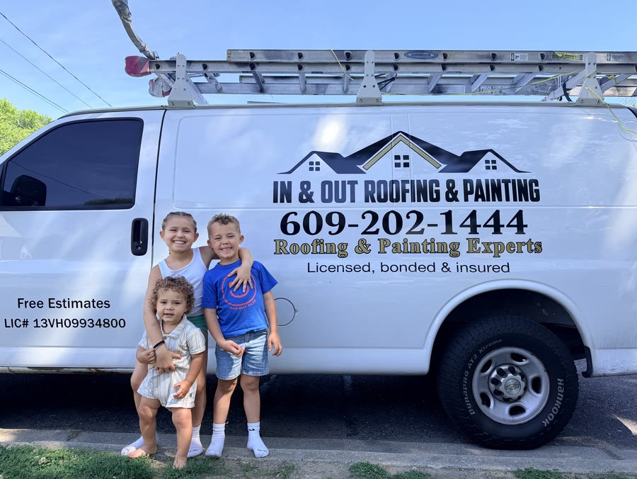 Jamar's kids in front of the In & Out Roofing & Painting work van