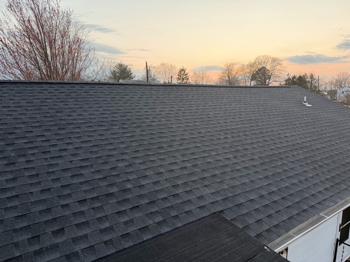 New architectural shingle roof at sunset
